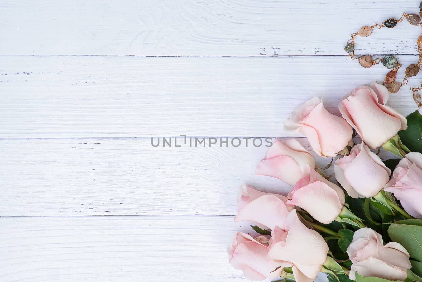 Beautiful bouquet of pink roses on pale blue colored wood background. Flat lay. Love, Romance, Valentine's Day, Anniversary.