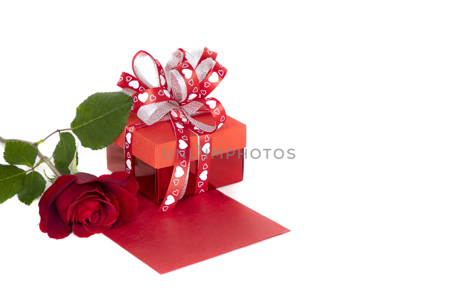 Beautiful red rose and red present box with red envelope, isolated on white background.