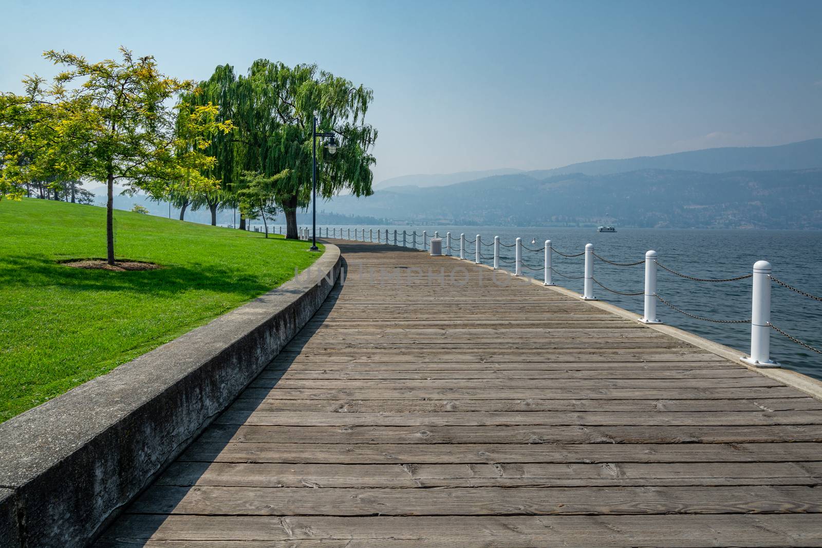 Wooden boardwalk along the waterfront on Okanagan lake in British Columbia