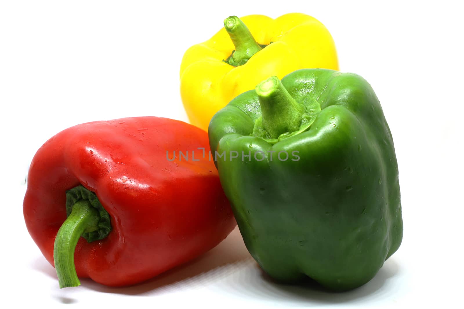 red, green, and yellow bell pepper isolated on white background