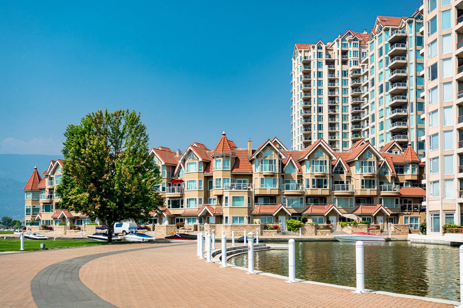 Luxury residential buildings with boat pier at the entrance. House at waterfromt in British Columbia