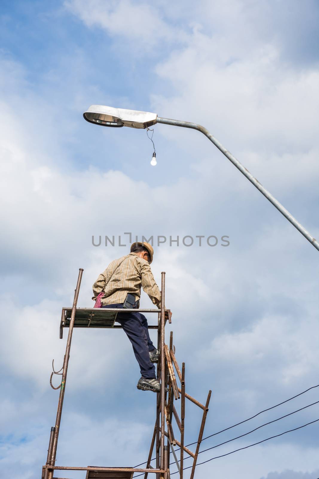 Bangkok, Thailand - June 26, 2016 : Unidentified worker working to install electric line by scaffolding on pickup truck at Bangkok Thailand.