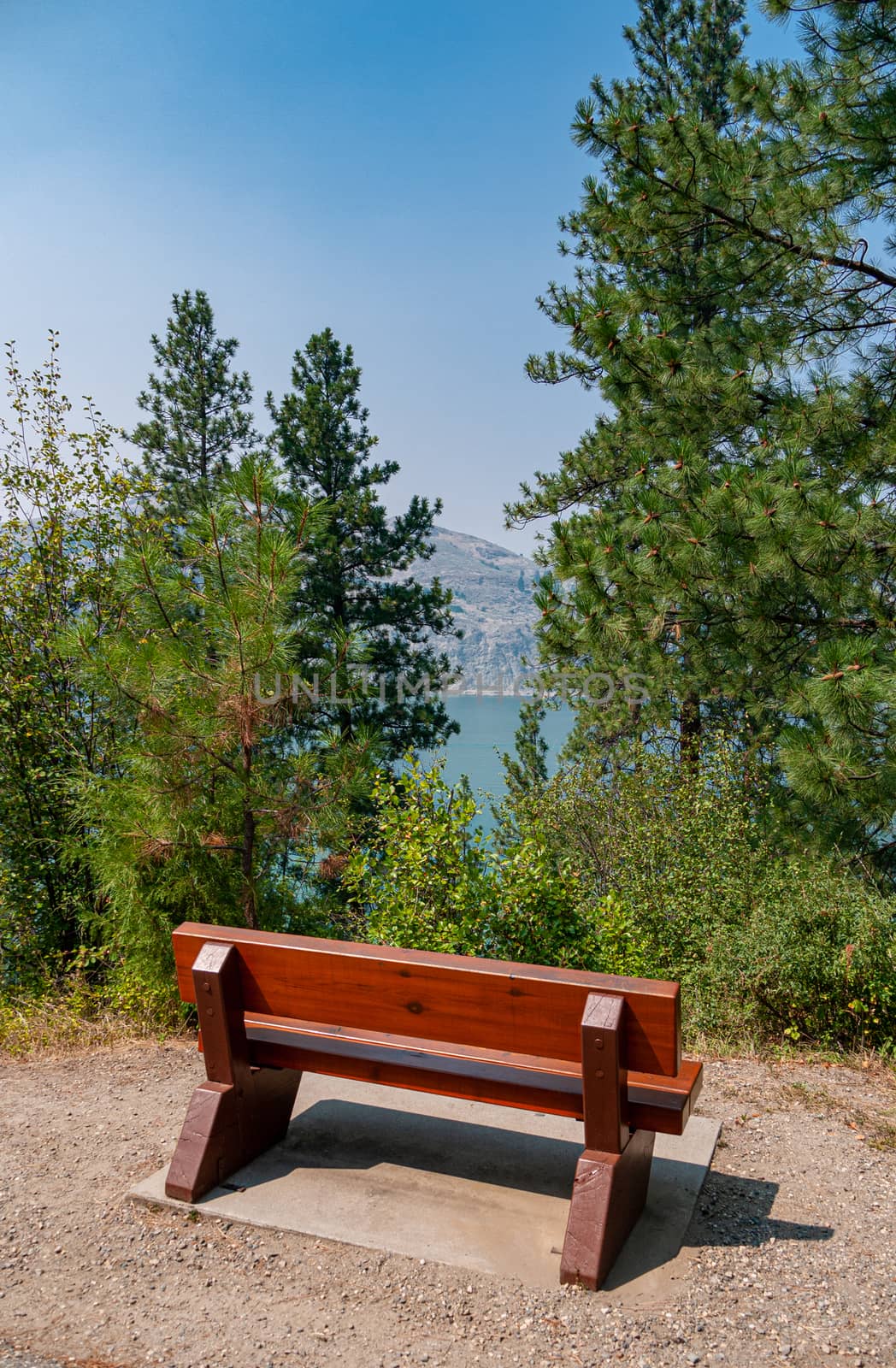 Wooden bench in rest area on hike route with beautiful view over a lake