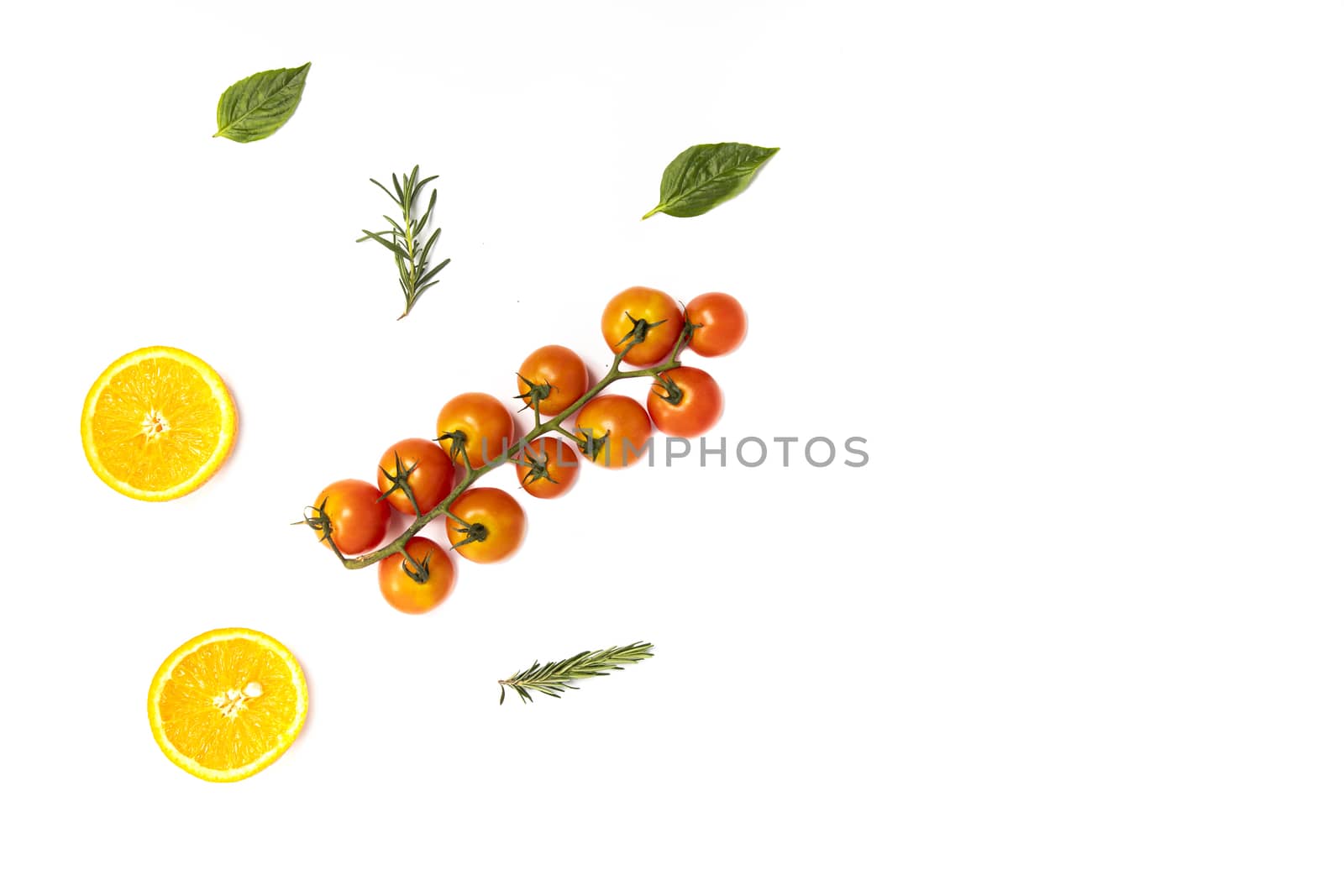 Colorful pattern of fresh summer orange slices and tomatoes with rosemary sprigs and basil leaves on white background. Top view.