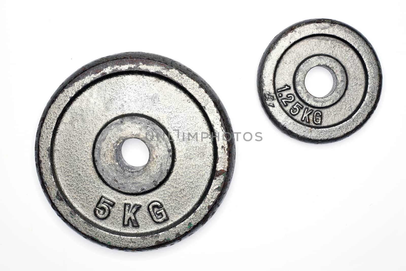 two old metal weight plates, isolated on white background