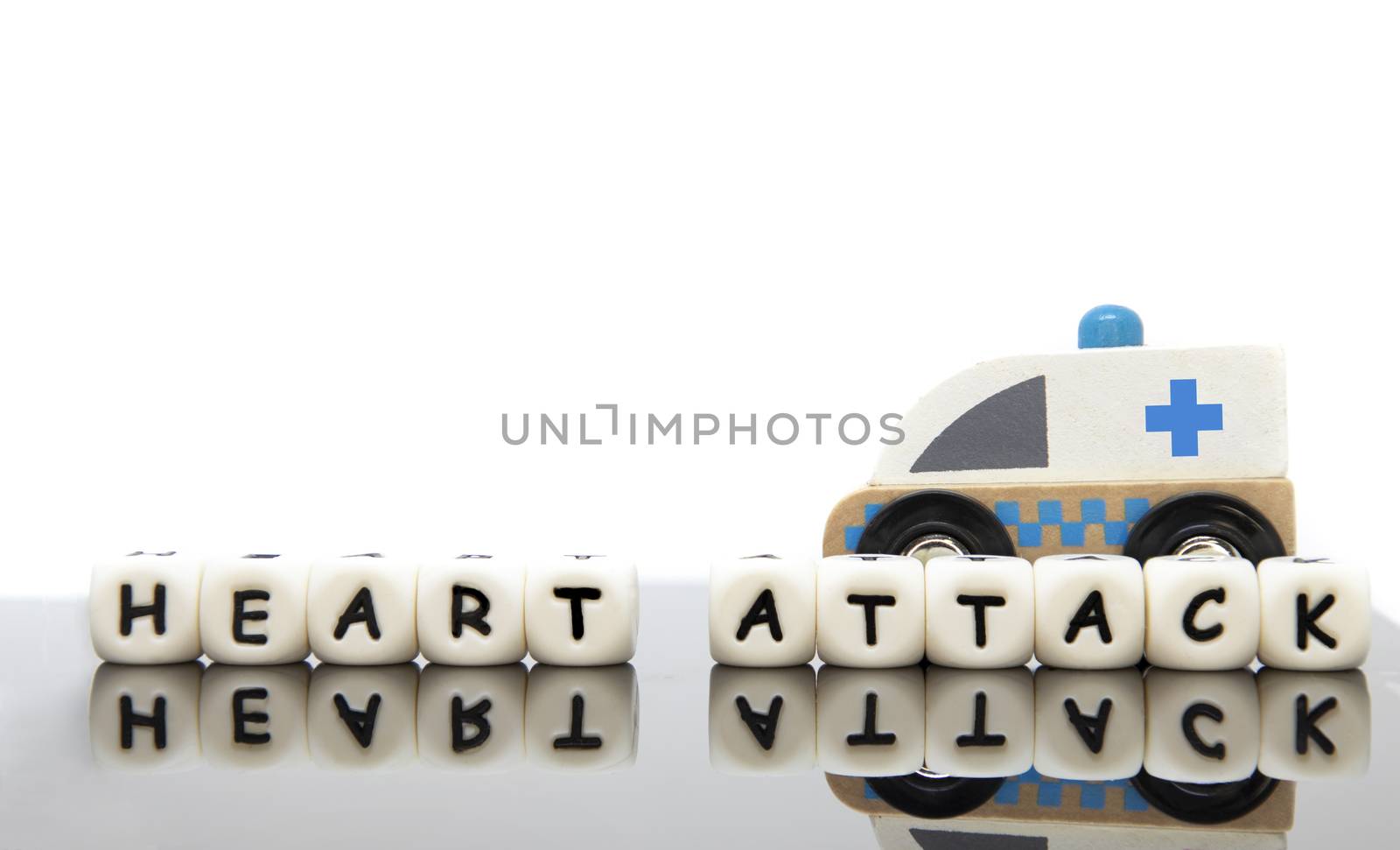 alphabet letters spelling the word heart attack and a toy ambula by Nawoot