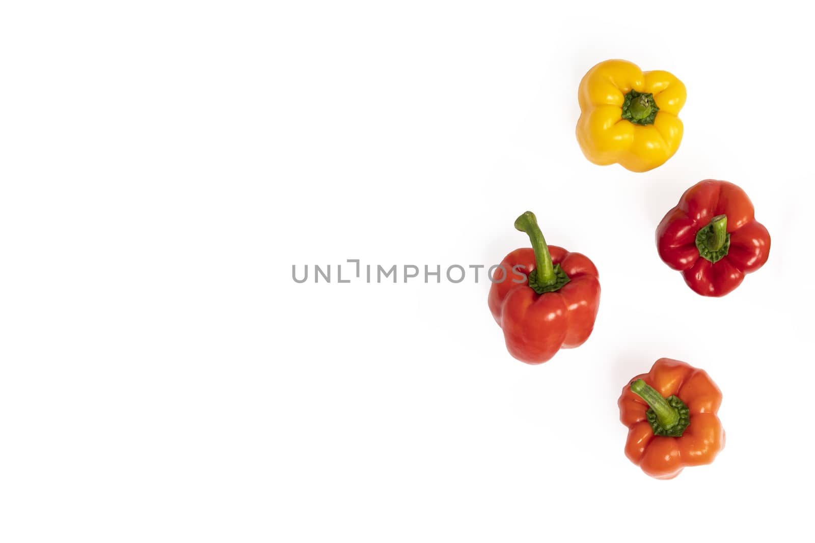 Colorful sweet bell peppers in red, orange and yellow. Isolated on white background