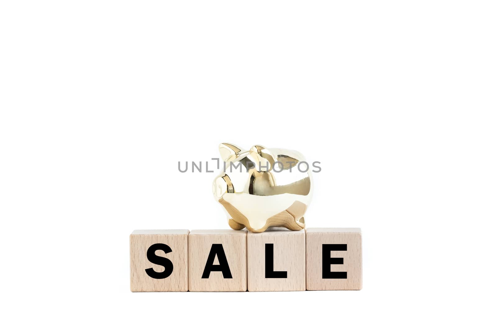 A gold piggy bank and wooden blocks with text. Isolated on white background. Sale concept.