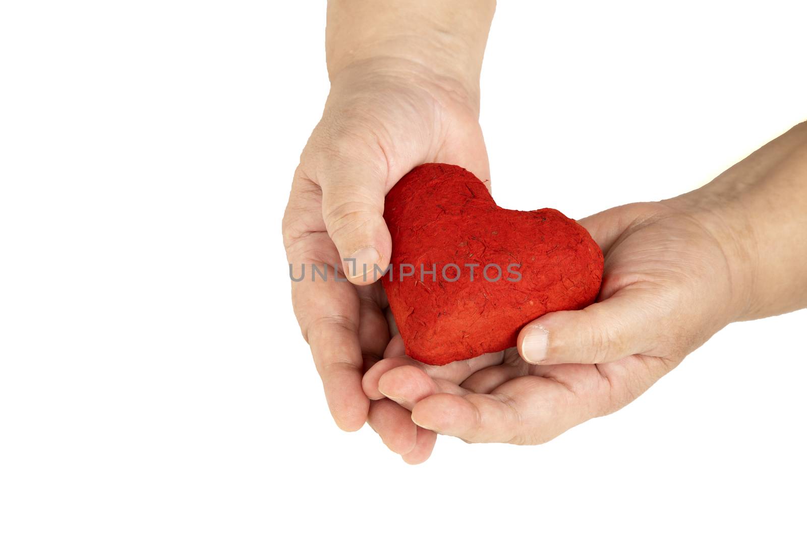 Hands of an elderly woman holding out or receiving a red heart. Love and Valentine concept. Isolated on white background.