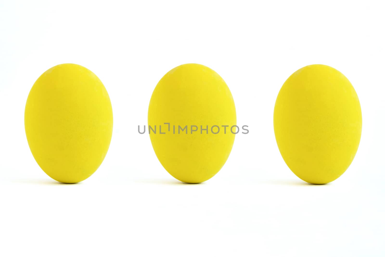 Three yellow paint eggs. isolated on white background