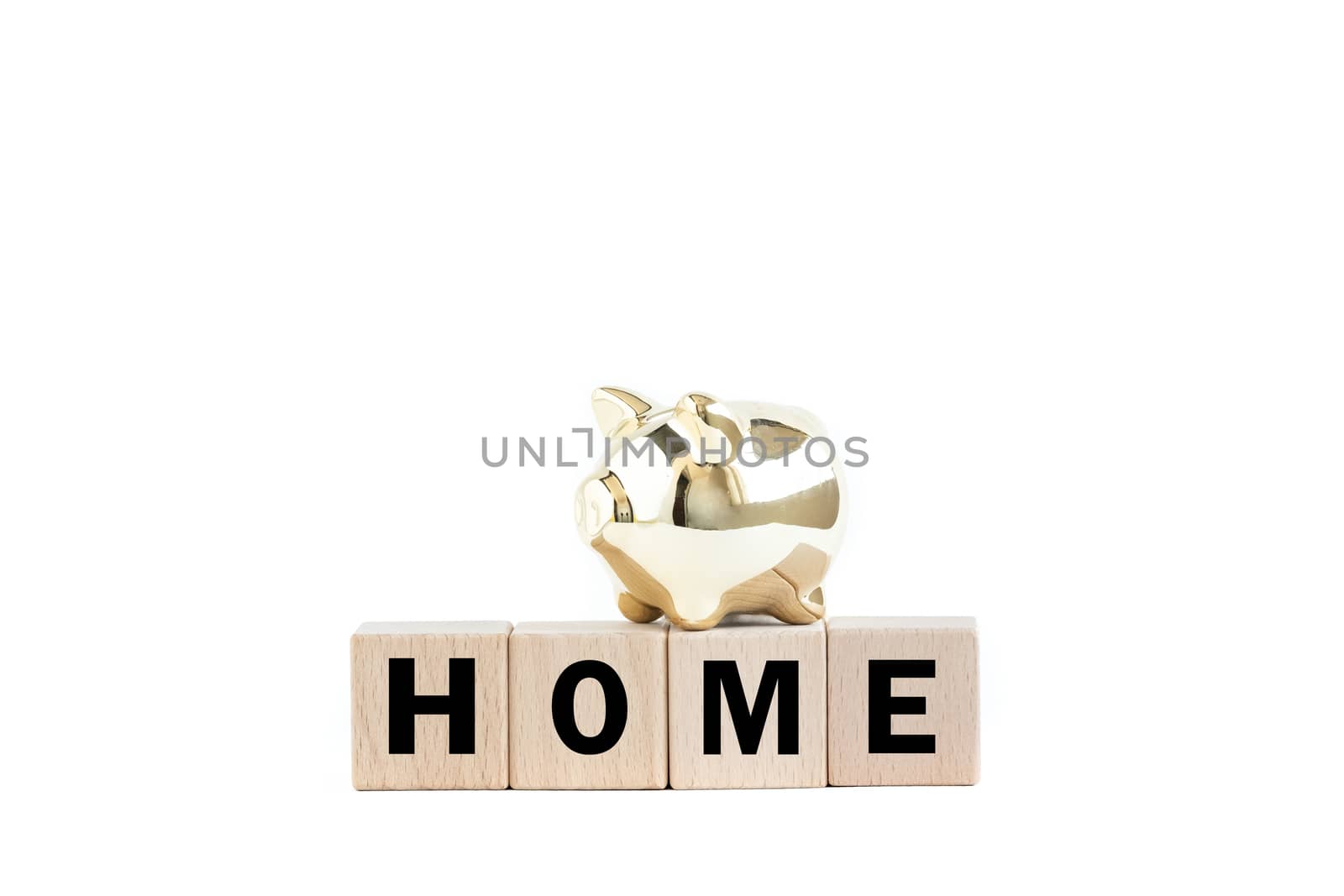 A gold piggy bank and wooden blocks with text. Isolated on white background. Home concept.