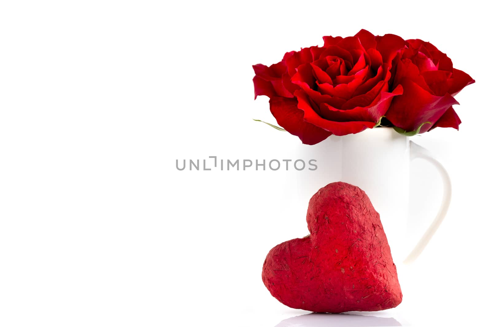 Blooming red roses and red paper mache heart, isolated on white background. Love, romance, Valentine's Day.