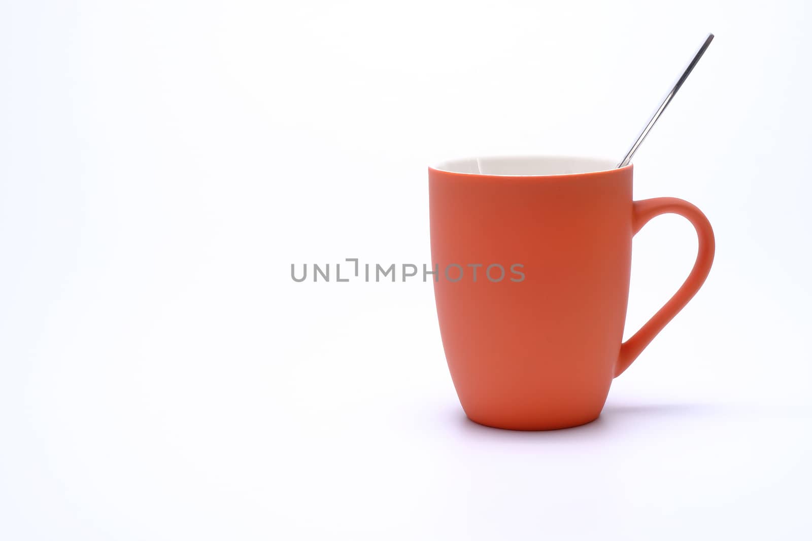 colorful coffee mug and spoon isolated on white background