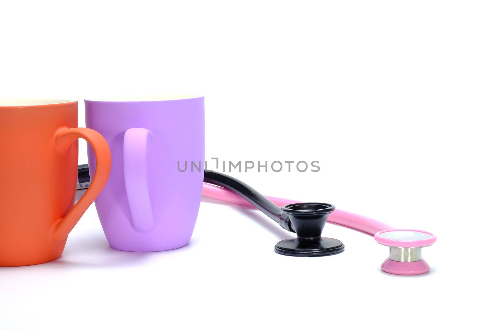 two coffee mugs and two stethoscopes on white background