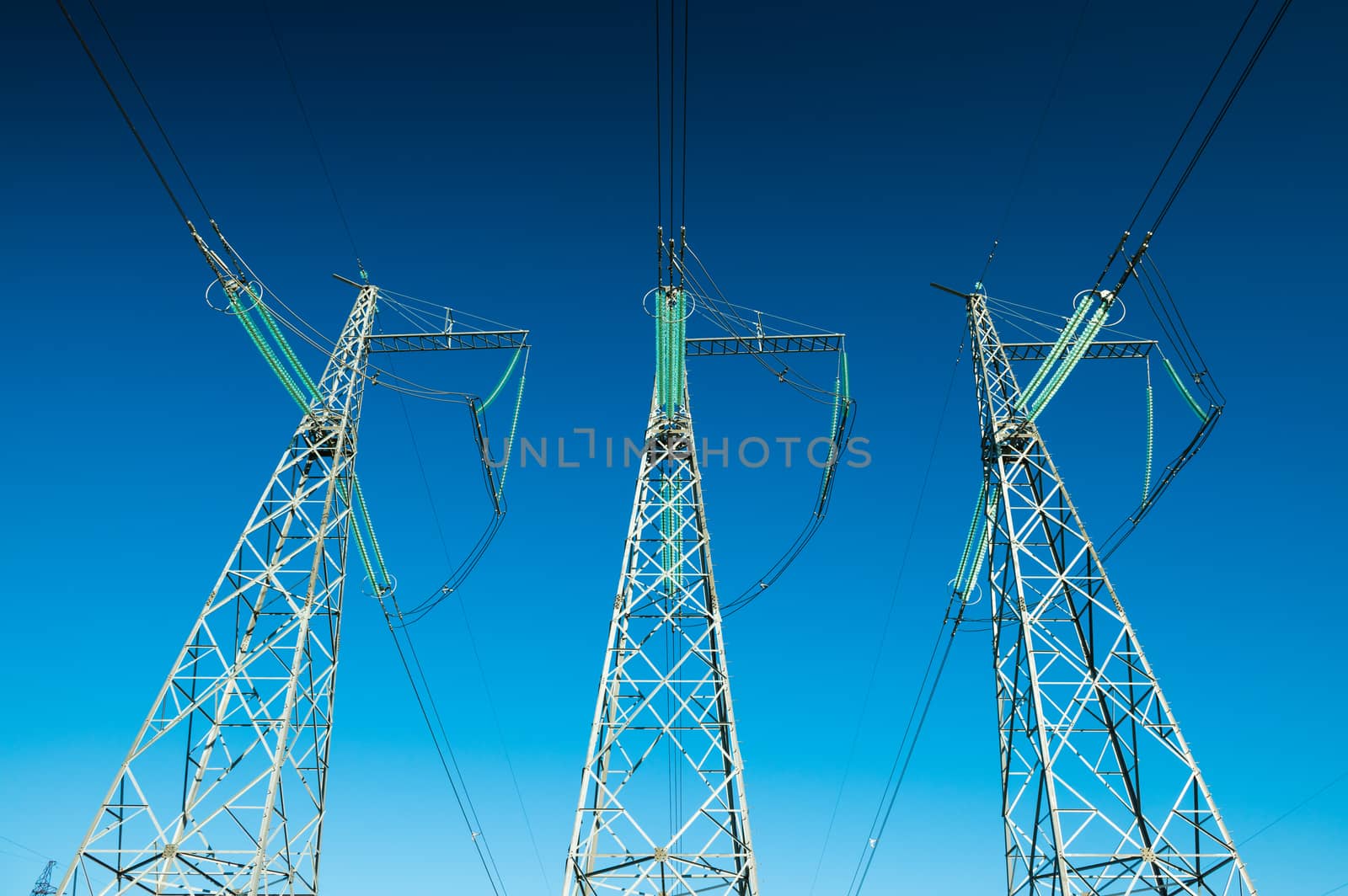 Electricity pylons in wide angle perspective, high voltage power lines, background photo, minimalism art