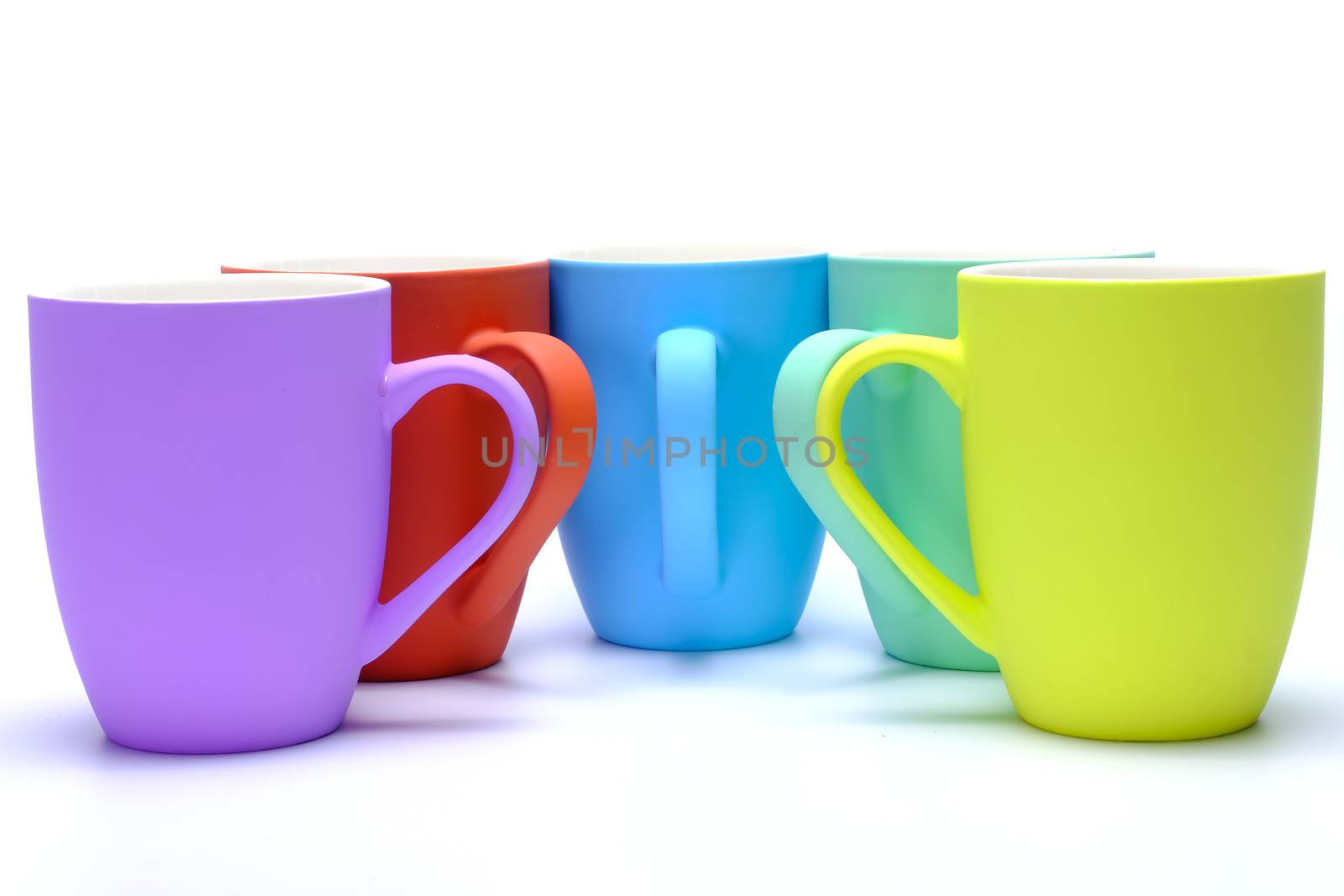 Colorful coffee mugs on white background