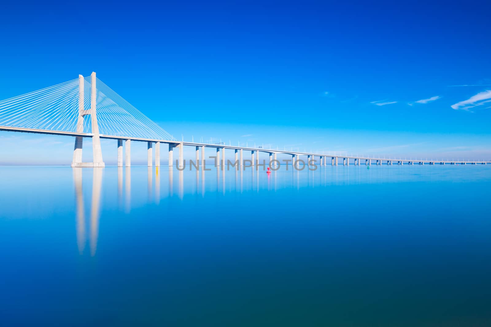 Vasco da Gama Bridge mirrored on water, Lisbon, Portugal