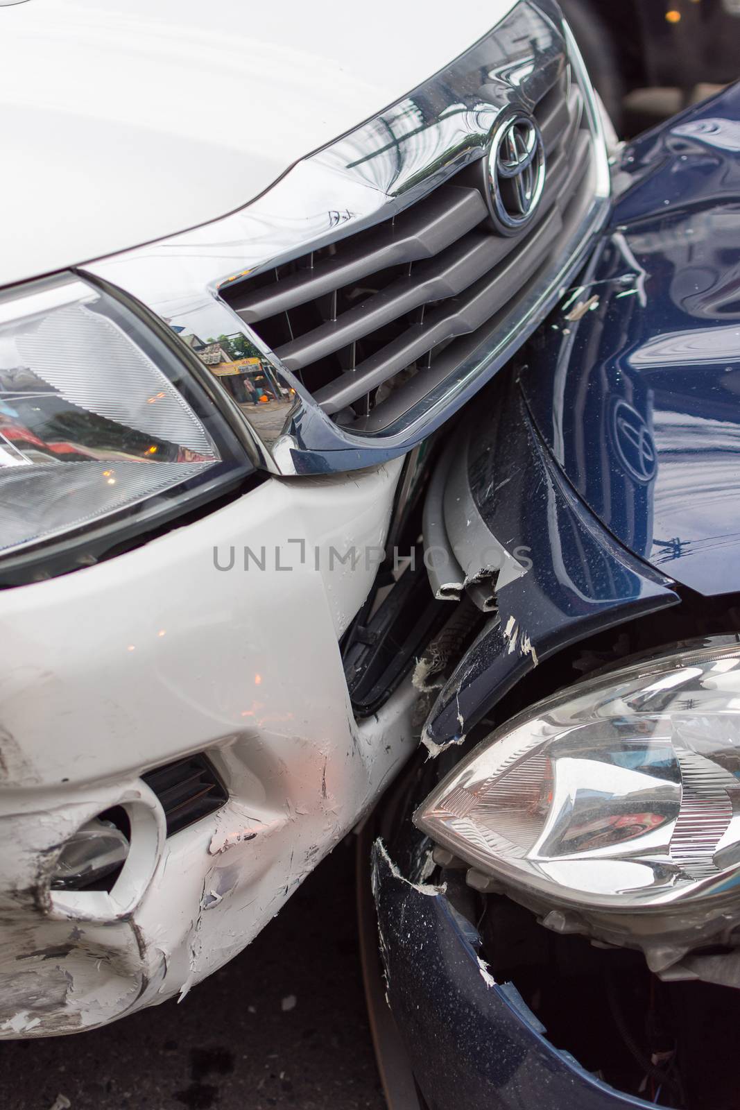 Bangkok, Thailand - June 17, 2016 : Car crash from car accident on the road in a city between saloon versus pickup wait insurance.