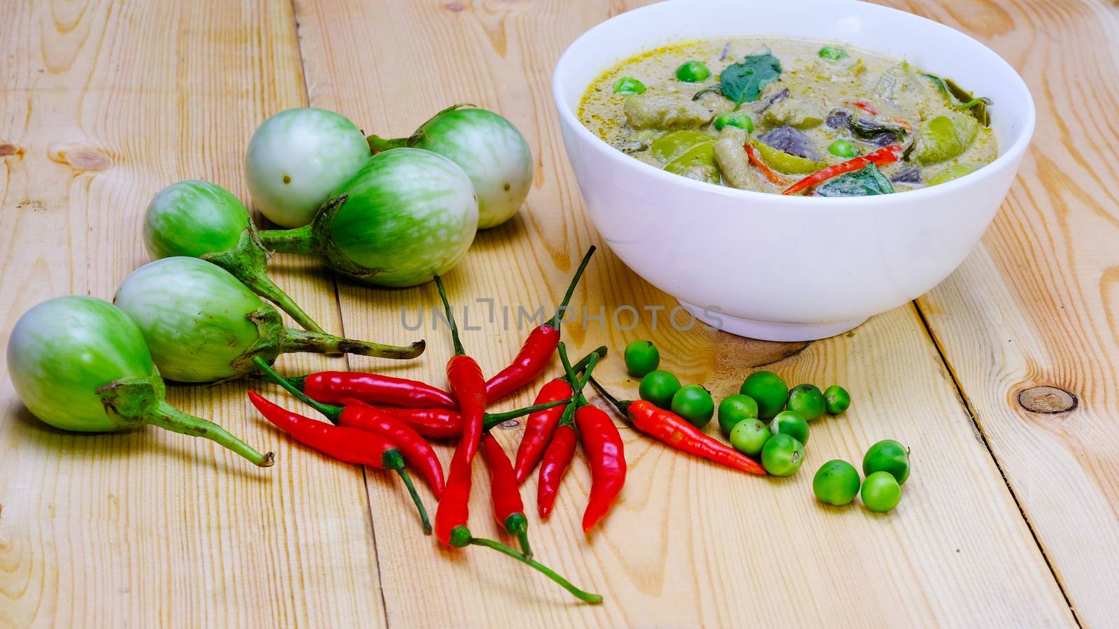 Ingredients for making famous Thai Green Curry with Chicken dish include, red and green chilli, holy basil leaves, kaffir lime leaves, turkey berry, and eggplant