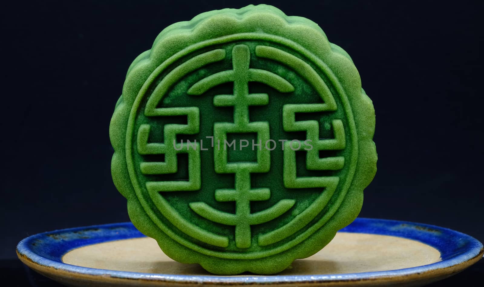 moon-cake, a traditional chinese dessert made of pastry with sweet cranberry and red bean paste fillings