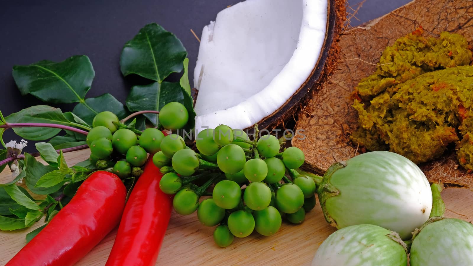 Ingredients for making famous Thai Green Curry with Chicken, Pork, or Beef dish include, red and green chili, holy basil leaves, kaffir lime leaves, turkey berry, and eggplant