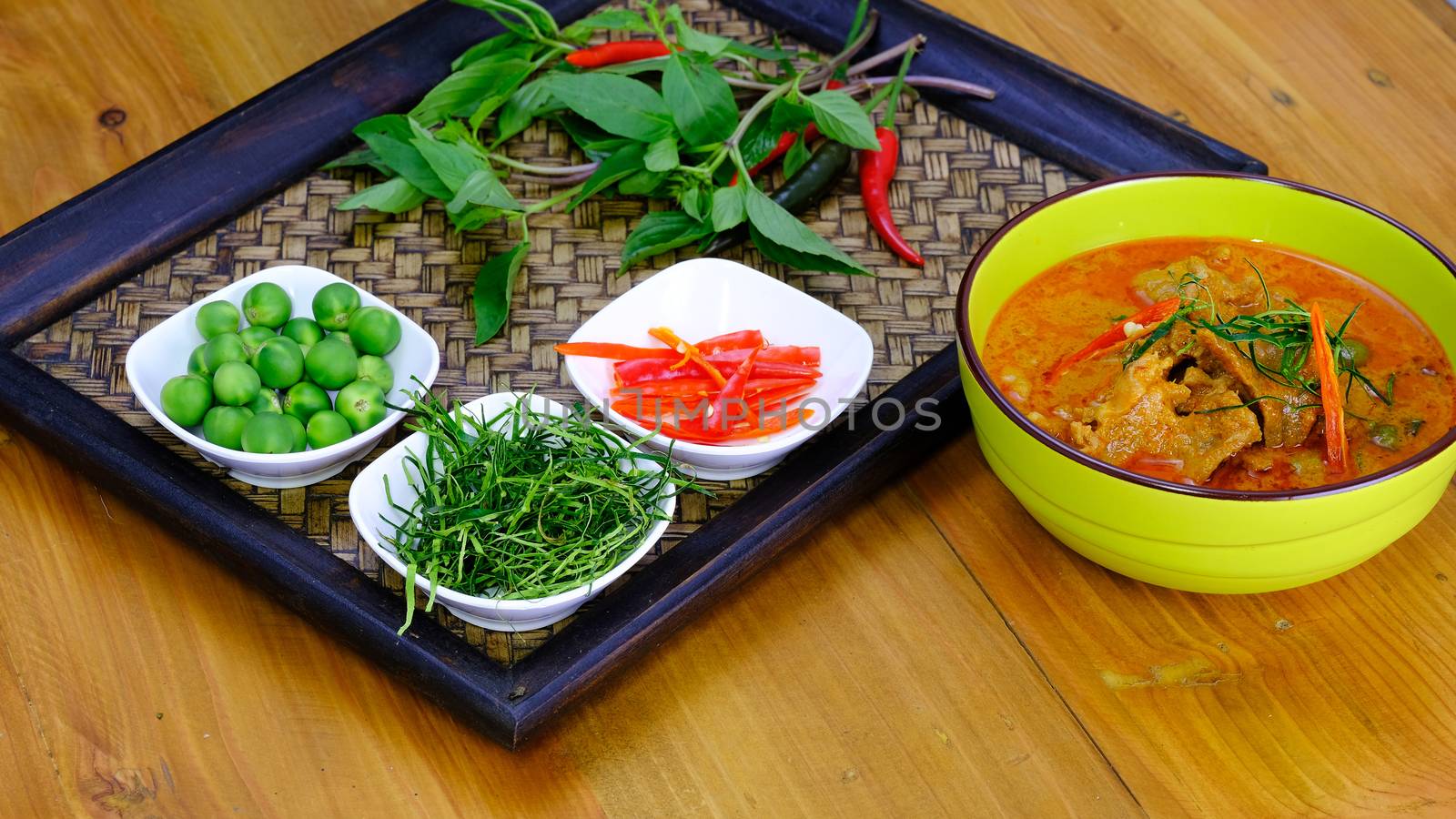 Ingredients for making famouse Thai (panang) dish include, red and green chilli, holy basil leaves, kaffir lime leaves, and turkey berry
