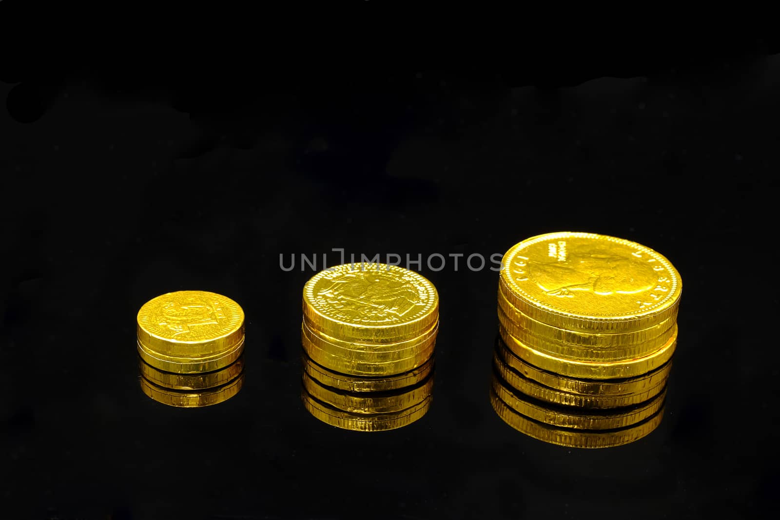a stack of (chocolate candy) gold coins symbolizing growing wealth