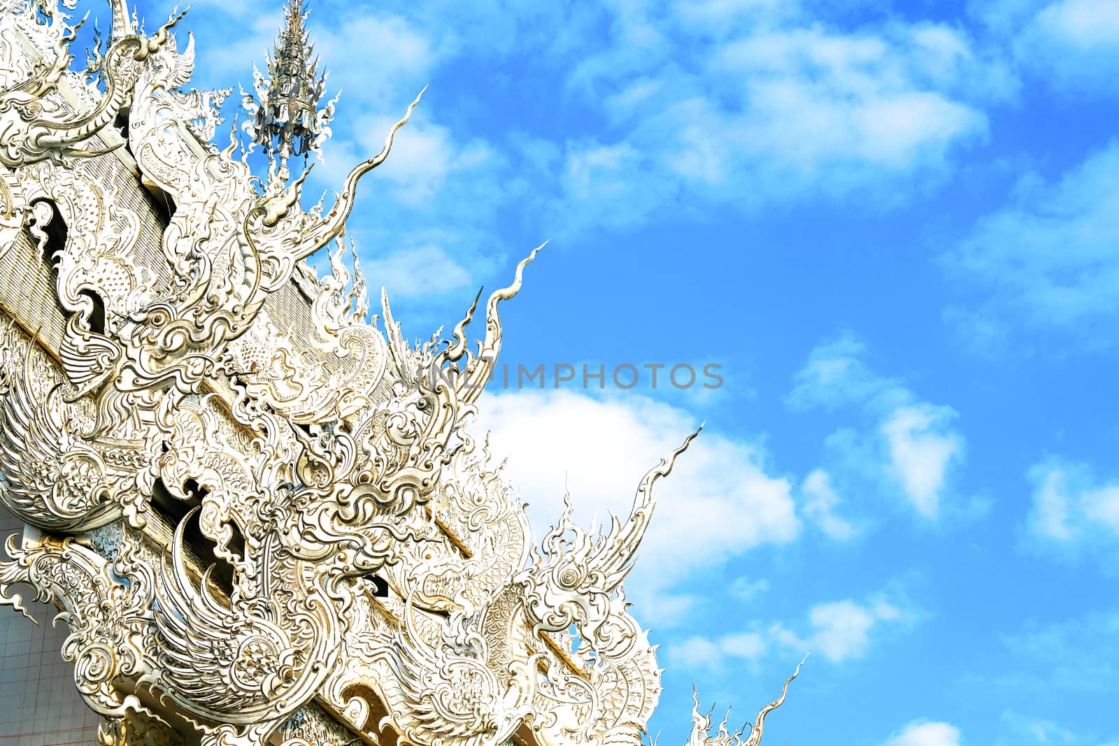details of Northern Thai Buddist temple roof with imaginative mystical creatures, elaborate stucco style