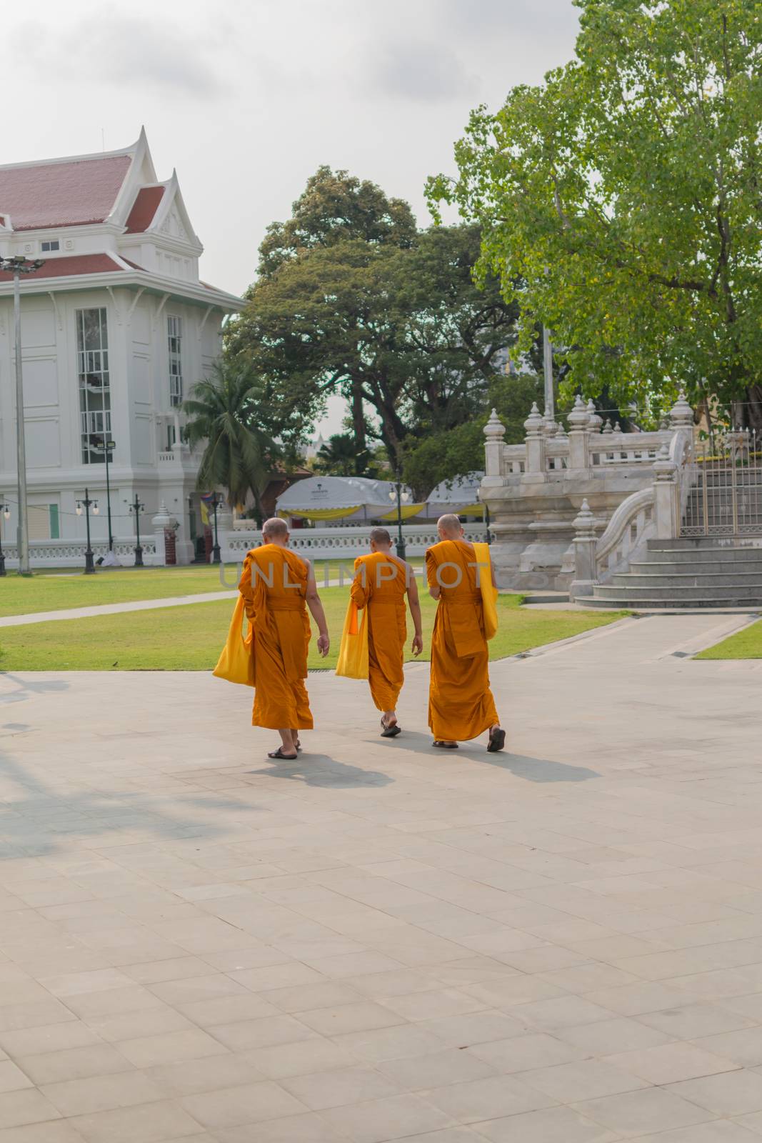Thai monk walking in temple to worship by PongMoji