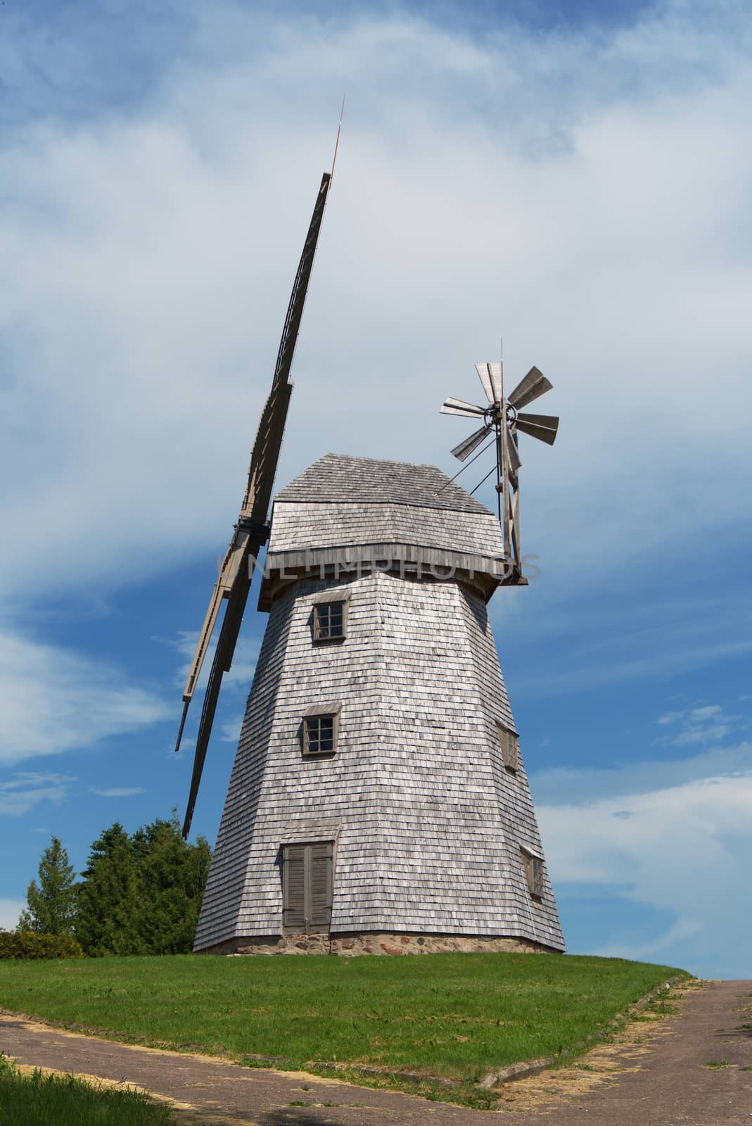 Old windmill in a country landscape by NetPix