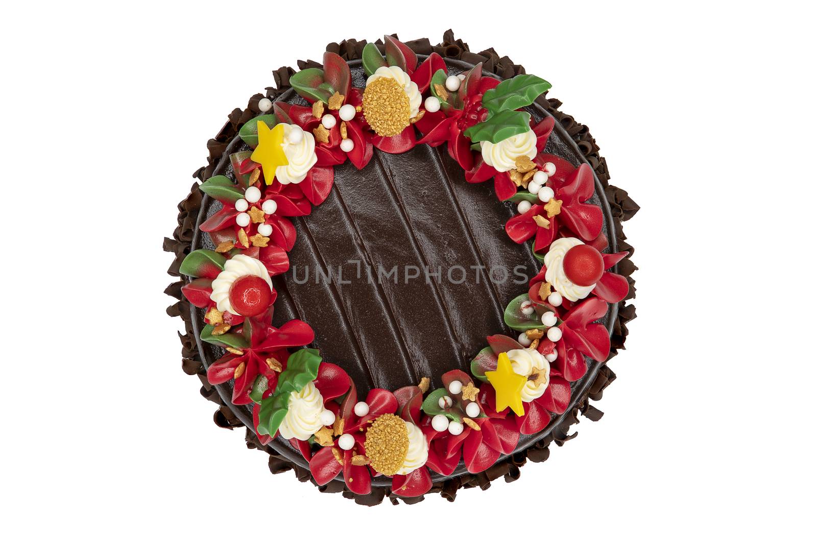 A chocolate cake decorated with red, white and green flowers and leaves, appropriate for Christmas and New Year celebration. Top view, closed up, isolated on white background with copy space.