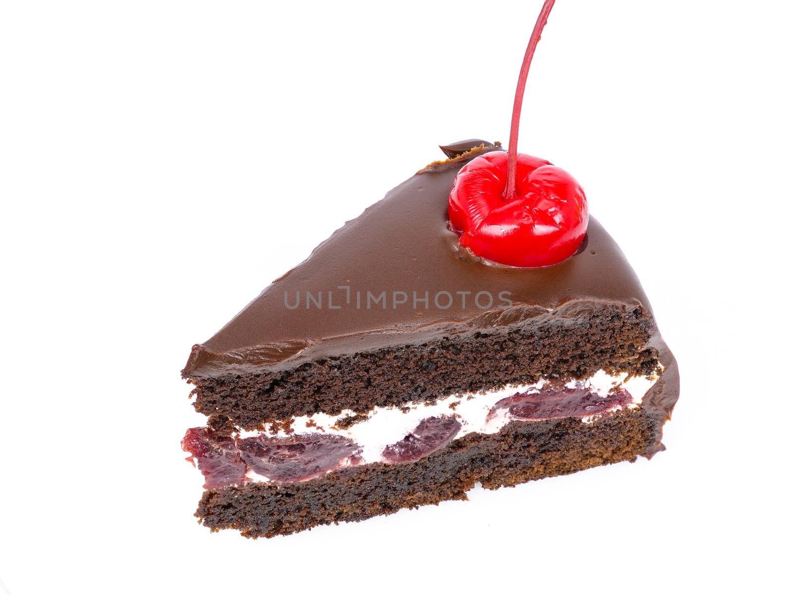 Top view shot of a slice of chocolate cake with cherries and cream filling and chocolate fudge (black forest cake) , isolated on white background