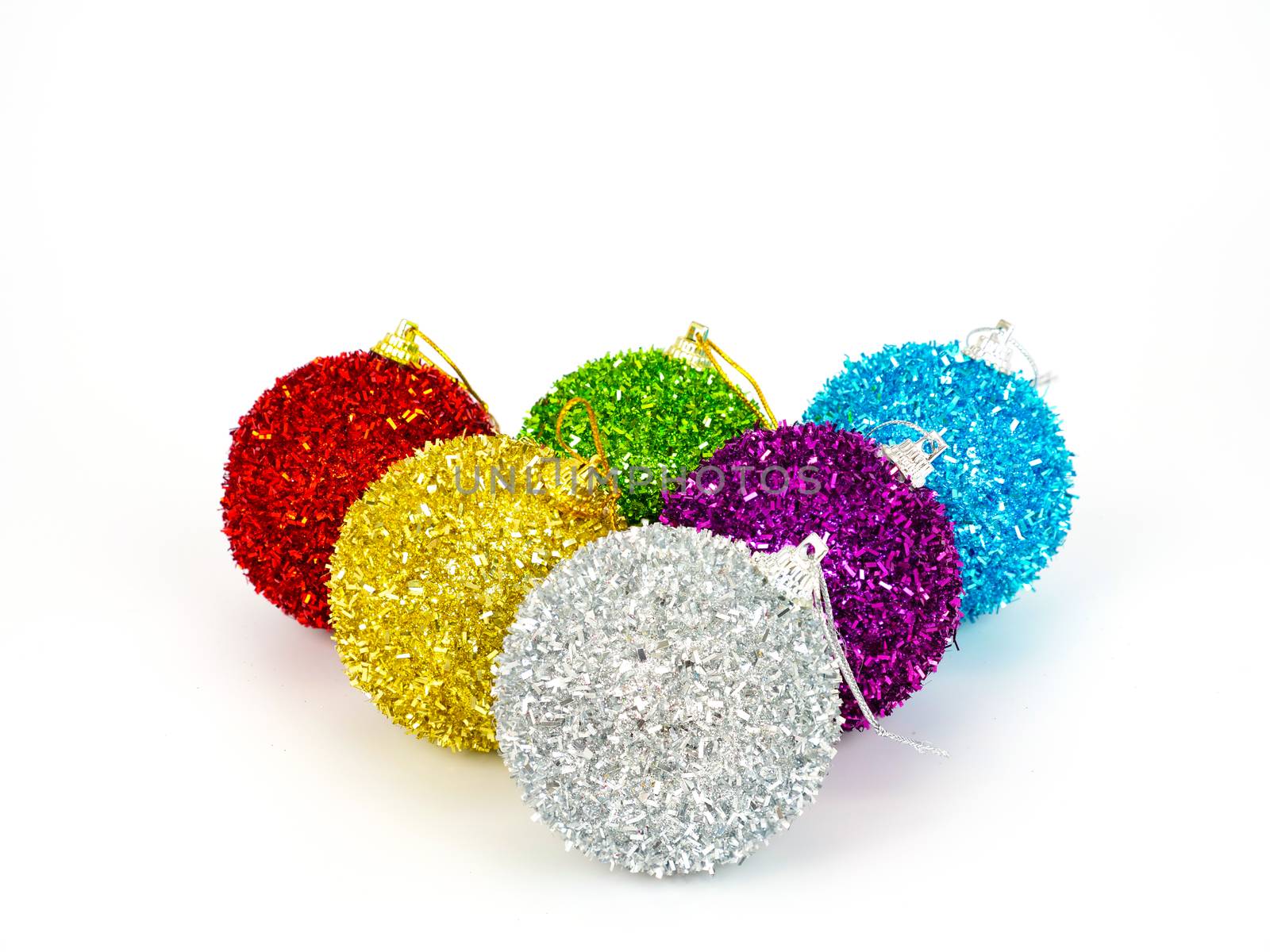 colorful christmas balls on the floor, isolated on white background