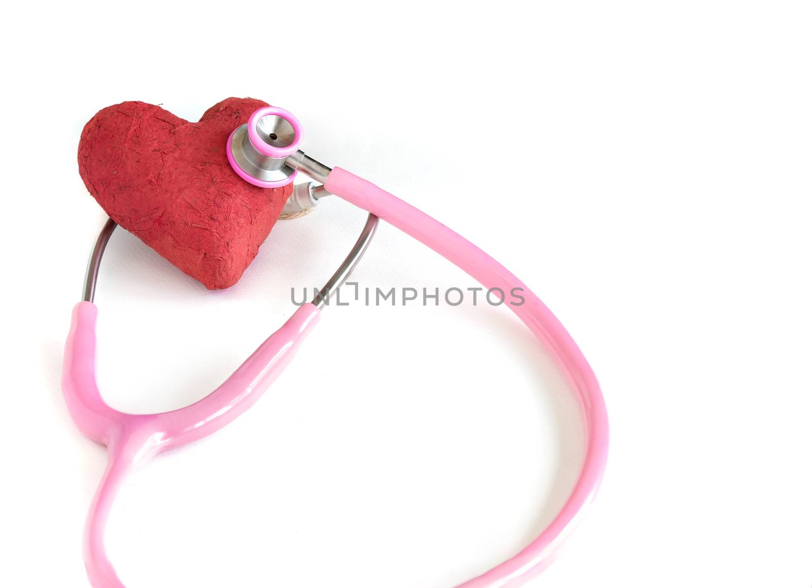 A stethoscope and a handmade red paper mache heart.