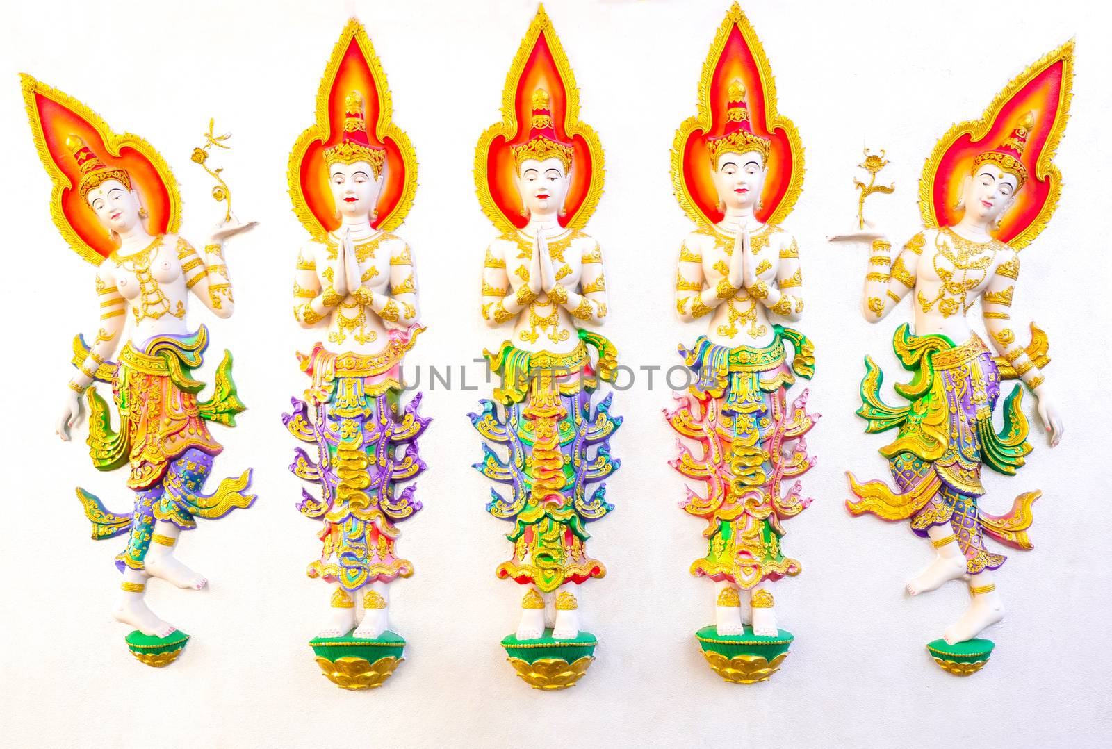 Beautiful painted stucco of angles on a white concrete wall. Thai temples are often decorated with stucco arts with religious motifs, with clipping path