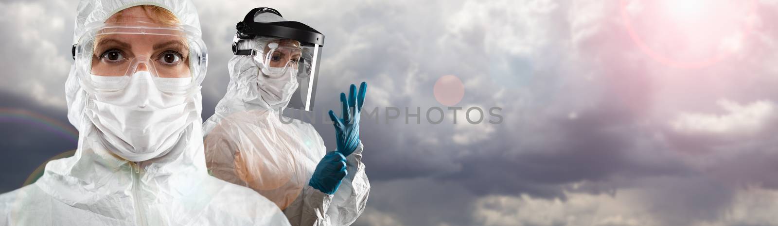 Doctor or Nurse Wearing Personal Protective Equipment Over Stormy Clouds Banner.