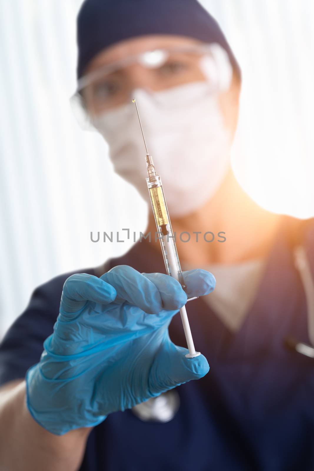 Doctor or Nurse Holding Medical Syringe with Needle.