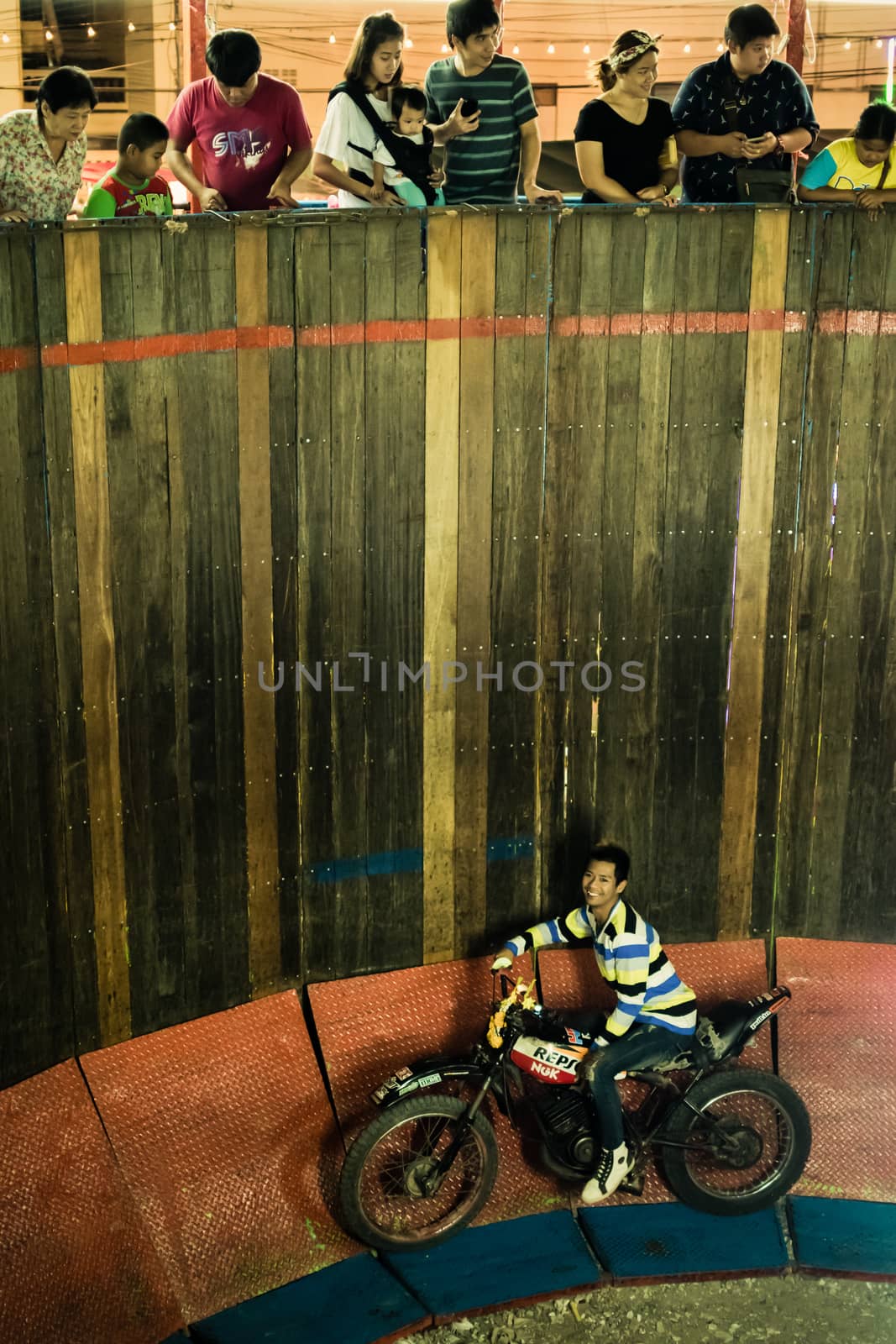 Bangkok, Thailand - January 9, 2016 : Unidentified asia rider motorcycle extreme show by climb and run on the circle wooden wall in a temple festival.