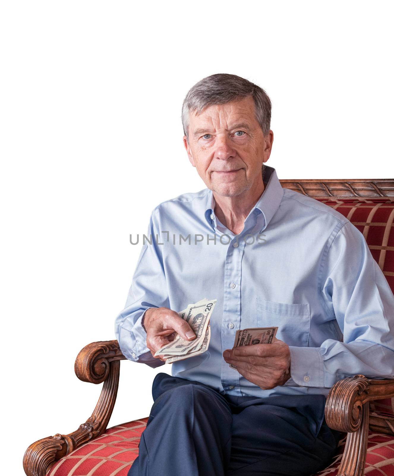 Senior man facing camera and counting out US dollar bills as though handing to viewer by steheap