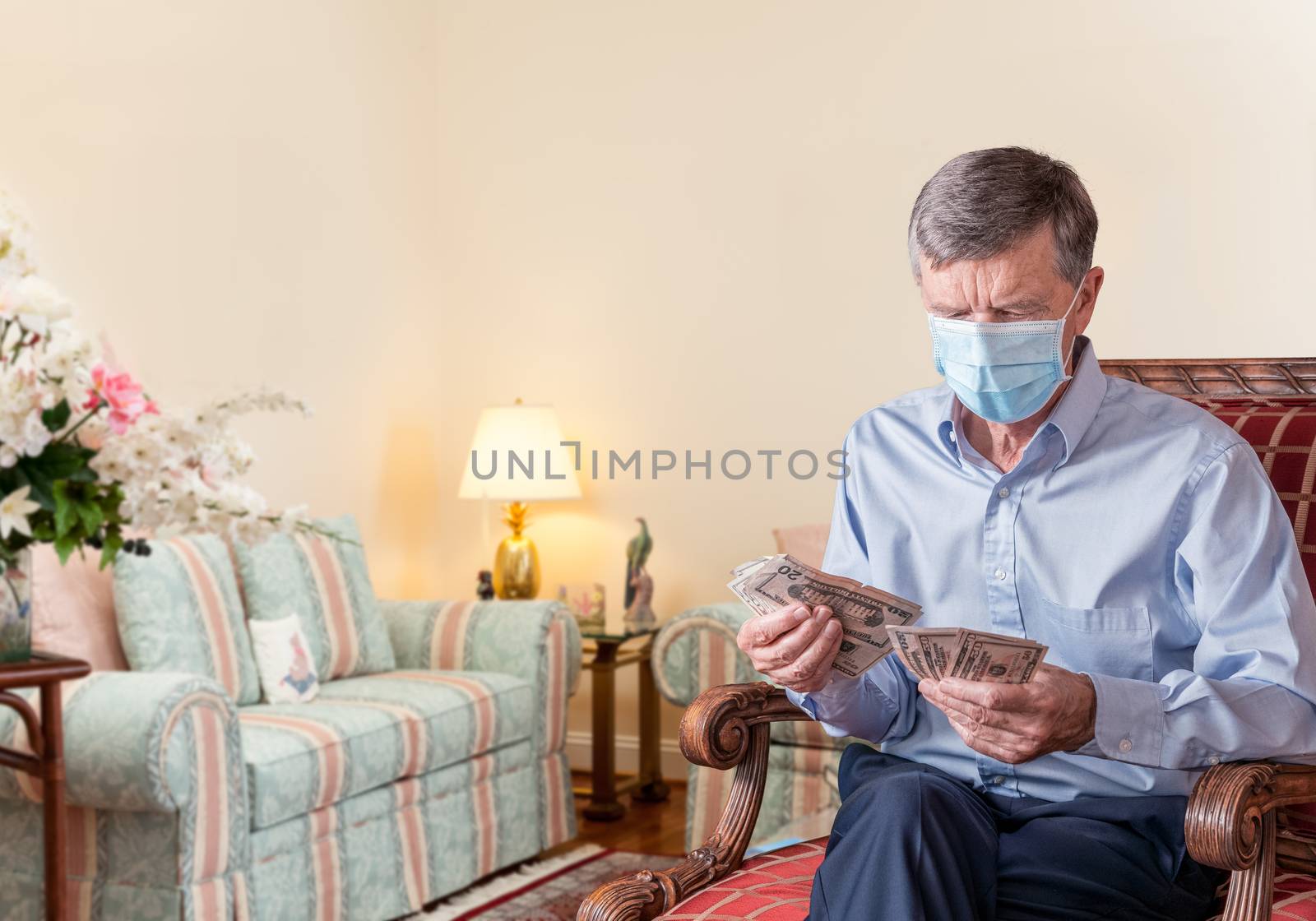 Senior man counting out US dollar bills with face mask and looking worried by steheap