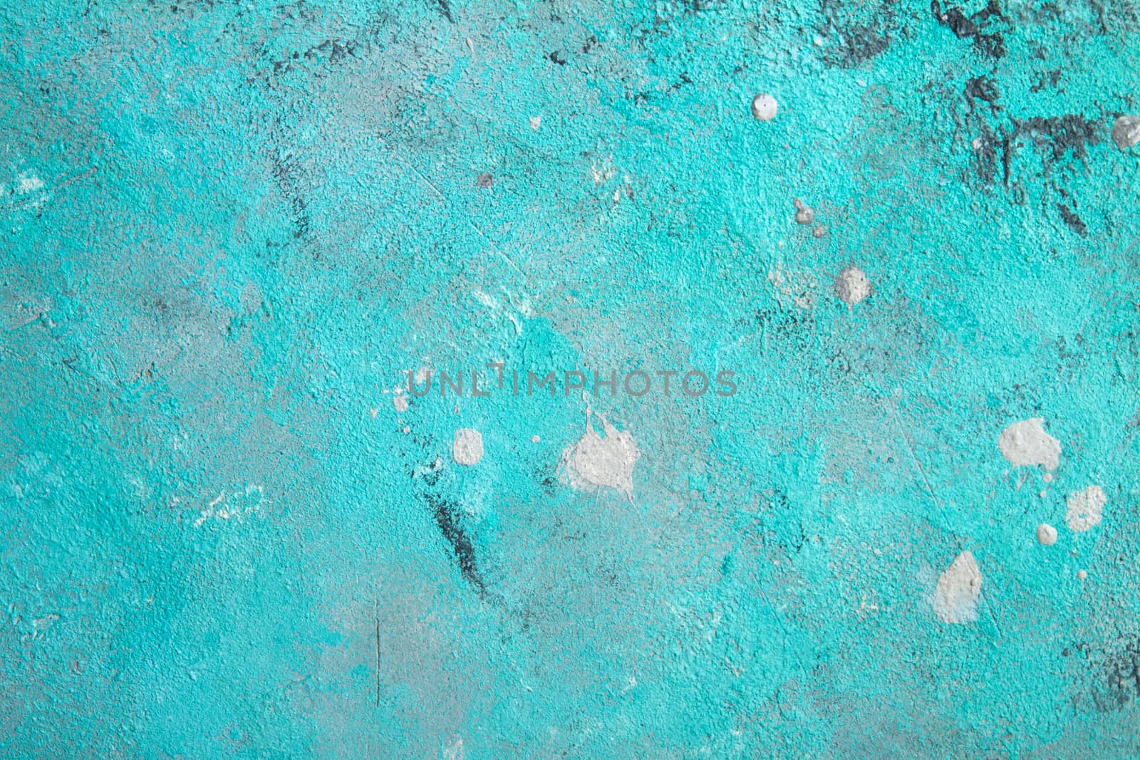 Concrete emerald green background with scuffs and black splashes. Textured wall texture in the grunge style.