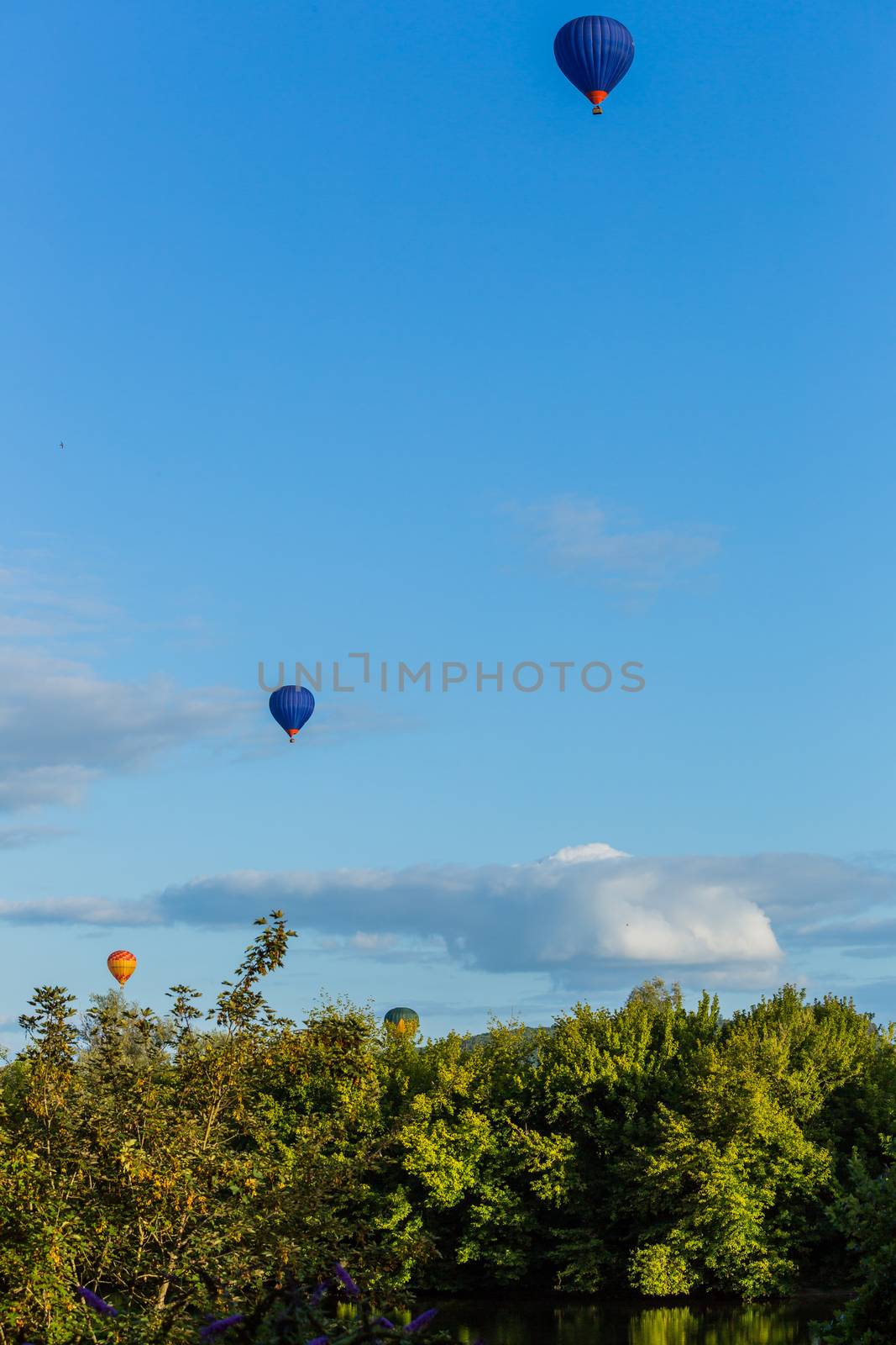 Hot air balloons flying over Dordogne in southwestern France