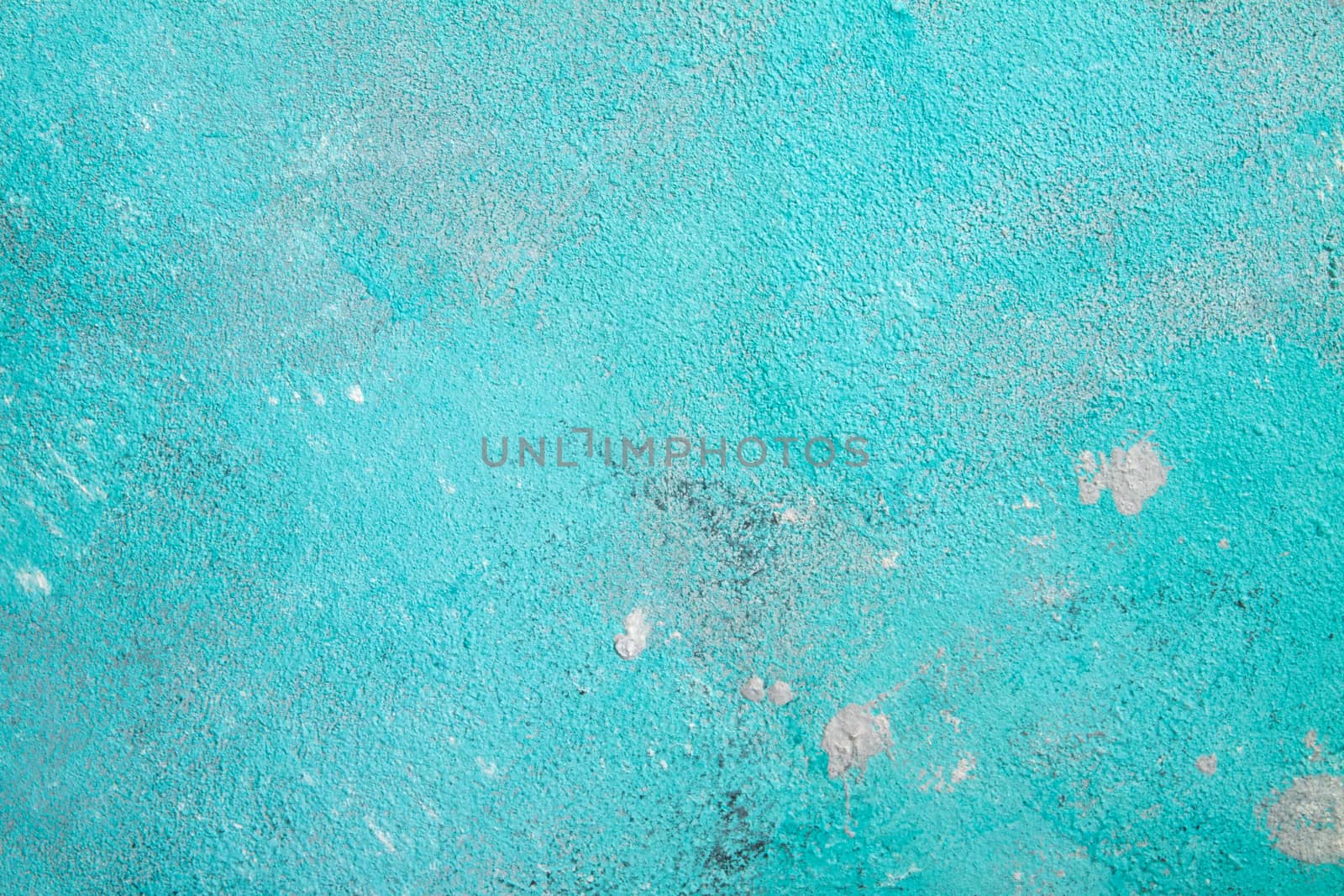 Concrete emerald green background with scuffs and black splashes. Textured wall texture in the grunge style.