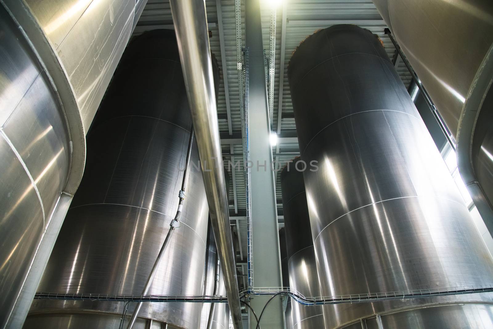 Grain processing facility inside. Industrial factory silos and equipment for food production