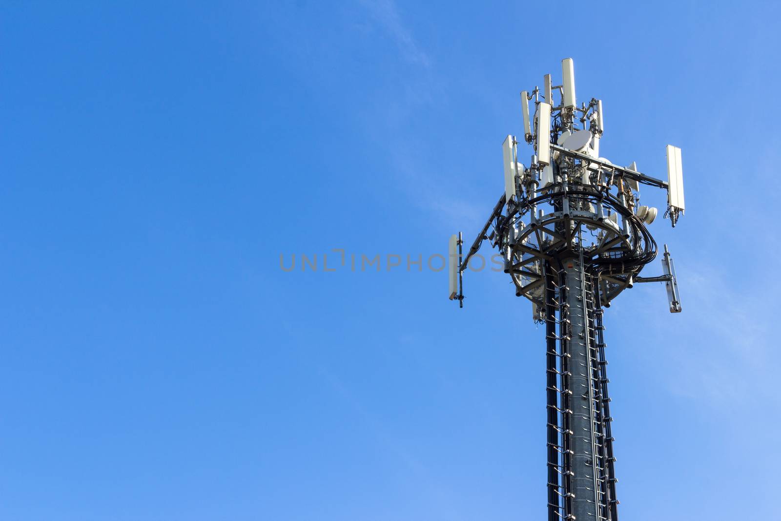 Telecommunication tower on blue sky background