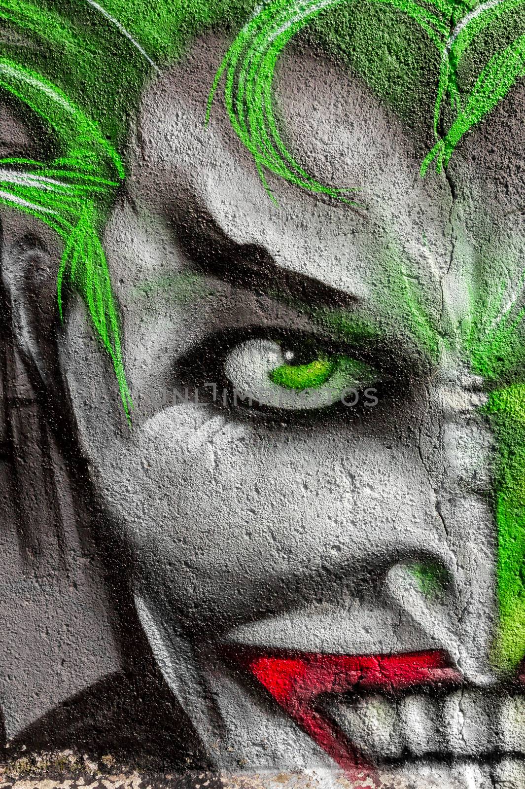 Detail of a graffiti with painting face. Street Art/Graffiti by unknown artist.