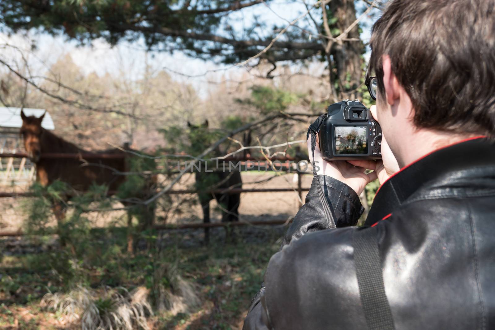 Close Up of a young caucasian man seen from behind taking a pict by germanopoli