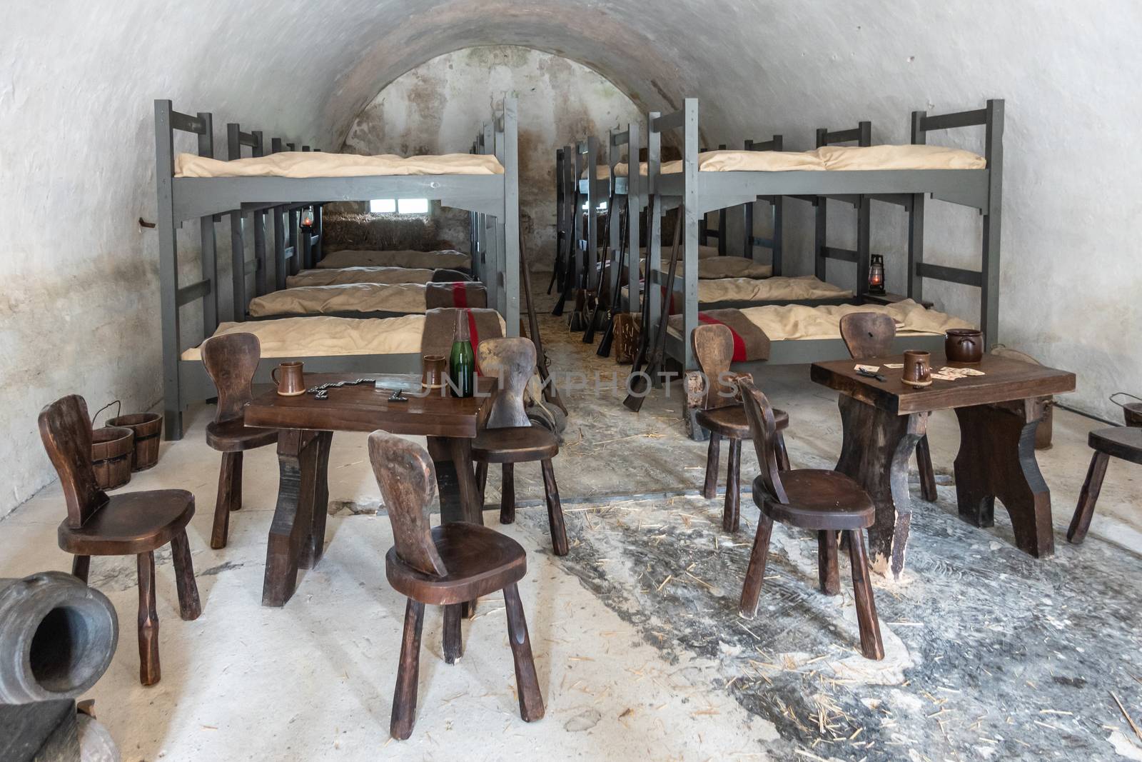 Dinant, Belgium - June 26, 2019: Inside Citadelle. Soldier barraks with bunk beds and a couple of tables and stools.