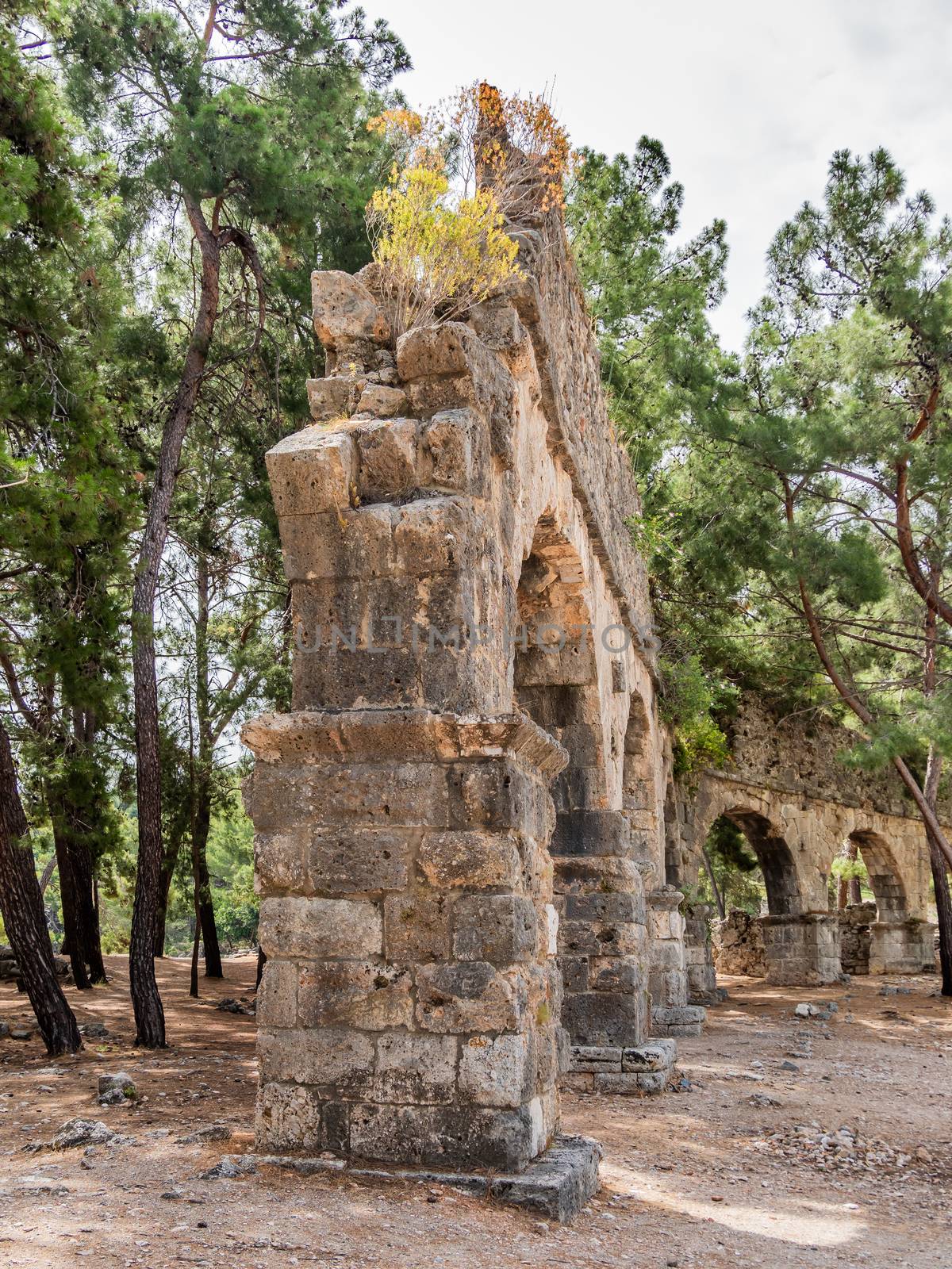 Ruins of aqueduct of ancient Phaselis city. Famous architectural by aksenovko
