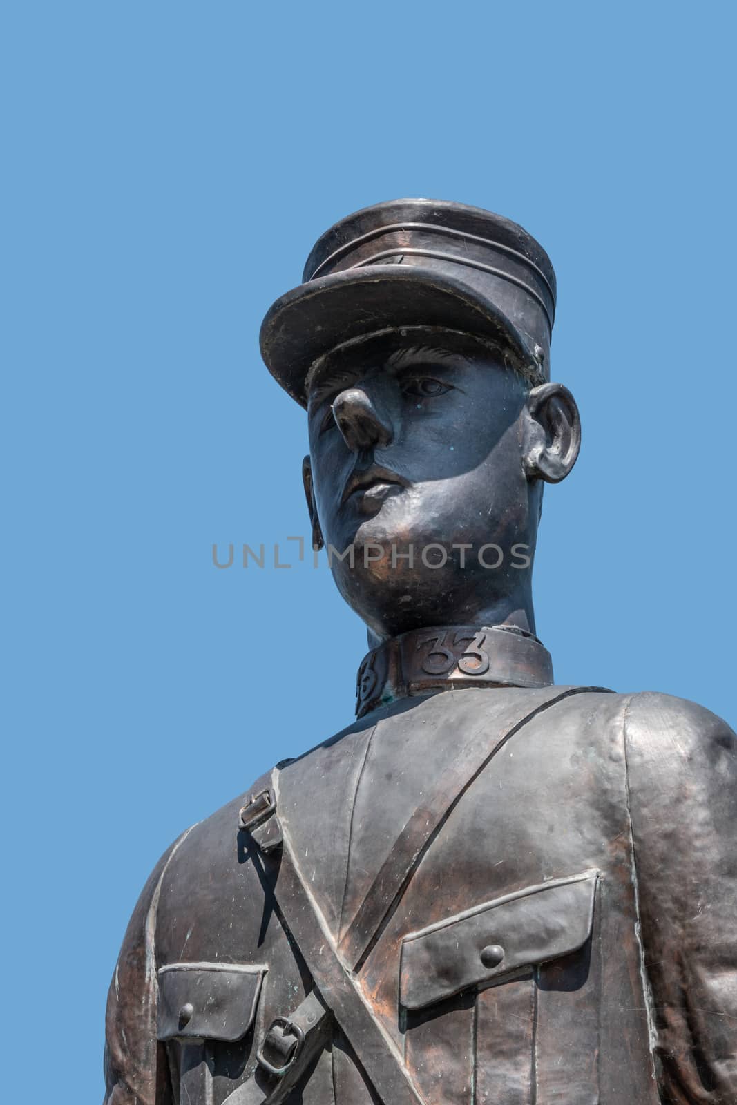 Dinant, Belgium - June 26, 2019: Closeup of dark bronze bust and head of Charles de Gaulle statue against blue sky.